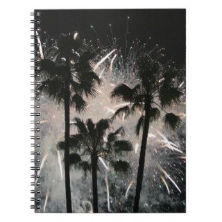 Fireworks behind palm  trees spiral note book