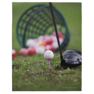 Golf ball on tee beside golf club jigsaw puzzle