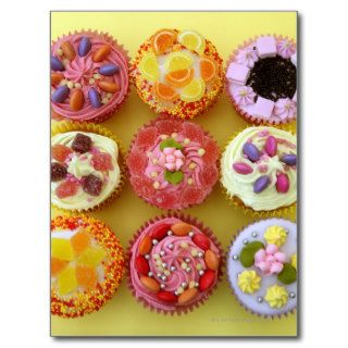Nine cupcakes each decorated with candy in a post cards