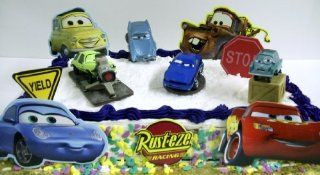 Disney Pixar Cars 2 11 Piece Cake Topper Featuring Professor Z, Acer, Finn McMissile, And Rod Redline. Also Includes Decorative Cars 2 Cake Pieces Featuring Lightning McQueen, Sally, Luigi, Mater, Red Ramone, 1 Yield Sign, 1 Stop Sign, and Rust eze Racing 