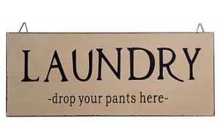 'laundry drop your pants here' sign by the contemporary home
