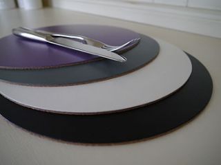 four leather placemats in muted colours by deservedly so