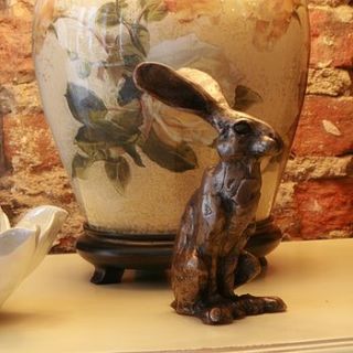 olly hare sculpture by candle and blue