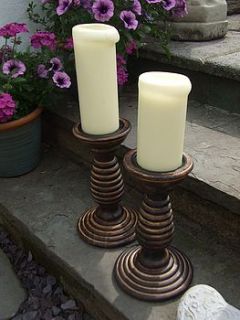 set two wooden candle hodlers by the hiding place