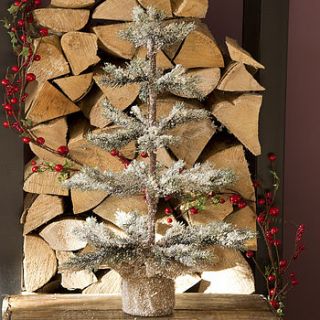 snowy christmas tree with jute base by ciel bleu
