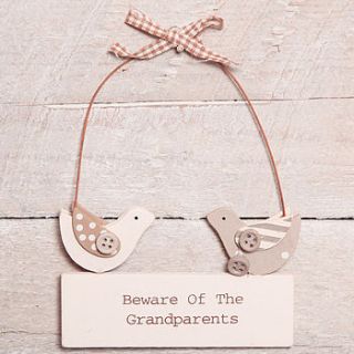 beware of the grandparents hanging sign by red berry apple