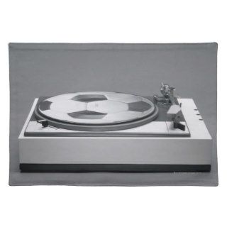 A disk with a soccer print on a record player placemats