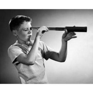 Boy looking through a hand held telescope Poster Print (18 x 24)